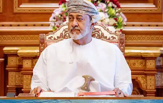 An image of Sultan Haitham bin Tariq, the ruler of Oman, signing a royal decree at the royal palace.