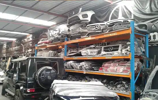 Warehouse filled with Mercedes-Benz auto parts including bumpers, grilles, and headlights Oman spare parts, auto parts shortage Oman