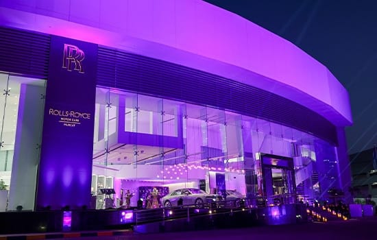 Exterior view of the new Rolls-Royce showroom in Qurum, Muscat, with modern architecture and purple lighting